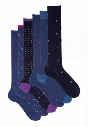 Six pairs of knee-high socks in various blue shades with small colorful embroidered patterns, arranged side by side.