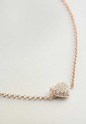 Collar de oro rosa con un colgante en forma de corazón, adornado con pequeñas piedras claras, que presenta un diseño de cadena enlazada.