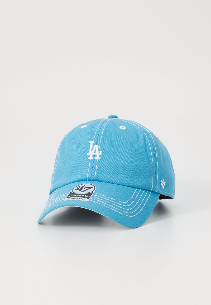 Light blue baseball cap made of cotton. Features white embroidered "LA" logo, adjustable strap, and contrasting stitching.