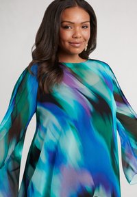 Flowing, multi-colored dress in blue and green hues with loose, sheer sleeves and a round neckline, featuring a smooth, lightweight fabric.