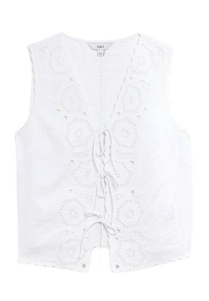 Witte linnen mouwloze top met geborduurde bloemmotieven, gegolfde randen en een voorknoopsluiting met decoratieve oogjes.