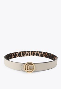 Ljusbeige läderbälte med ett guldformat spänne som har en logotyp. Inuti finns en leopardmönstrad design med en slät yta.