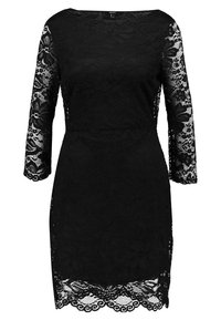 Svart spetsklänning med långa ärmar, prydd med ett blommönster och scallopad nederkant. Tillverkad av intrikat spetsmaterial för en texturerad yta.