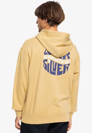 Felpa con cappuccio gialla a vestibilità rilassata, con una grande grafica testuale blu sul retro. Tessuto morbido con polsini e orlo a coste.