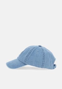 Denim cap in light blue with a curved brim, adjustable strap at the back, and six ventilation holes on the crown. Simple design.