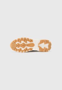 Rubber shoe sole with a patterned design; features a brown tread overlay and white midsole. Textured for grip and stability.
