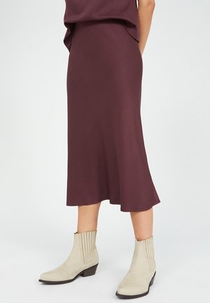 Burgundy midi-hame, jossa on liehuva helma, yhdistettynä beigeihin nilkkureihin, joissa on uritettu pinta ja matala kasa-heel.