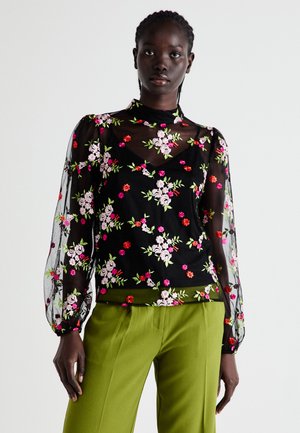 Black sheer blouse with floral embroidery in pink, red, and green. Features long, puffed sleeves and a V-neckline.