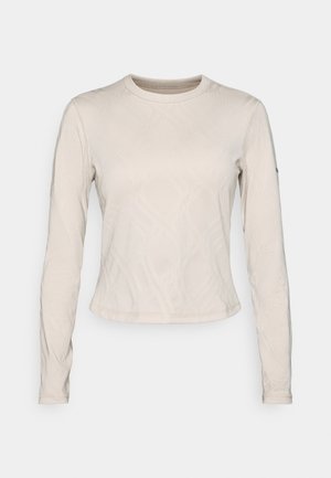 Long-sleeve top in a light beige color, featuring a textured pattern of intersecting lines, crew neckline, and slim-fit design.