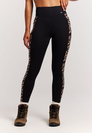 Zwarte legging met een luipaardprintaccent langs de zijkanten. Gemaakt van rekbaar materiaal, met een hoge taille en een enkellange pasvorm.