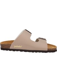 Beiger Schlittenschuh mit zwei verstellbaren Riemen, einem Korkfußbett und einer strukturierten Gummisohle. Mit "palado"-Markenlogo in Gold.