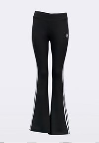 Black flared pants feature two vertical white stripes along the sides, crafted from a smooth, stretchy material. Small logo above waistband.