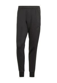 Zwarte polyester joggers met een elastische tailleband, taps toelopende pijpen en een subtiele embossed logo op de linkerdij. Ademend materiaal.