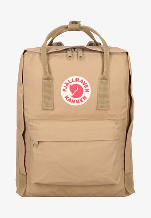 Zaino beige Fjällräven Kånken con due manici superiori, tasca frontale e un logo circolare con una volpe rossa. Realizzato in materiale durevole.