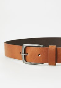 Brown leather belt with a silver metal buckle. Flat design, features punched holes for adjustability, and a smooth texture.
