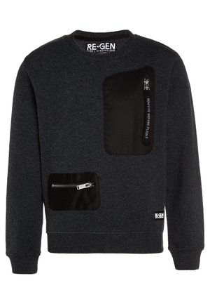 Dark gray crewneck sweatshirt with two black zippered pockets, one large on chest and one smaller near waist, with "REMOVE BEFORE FLIGHT" tag.