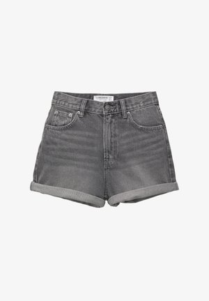 Sive traperice s odmotačima, s pet džepova i kopčanjem na dugme. Tkanina ima blago izblijeđenu teksturu i klasičan kroj.