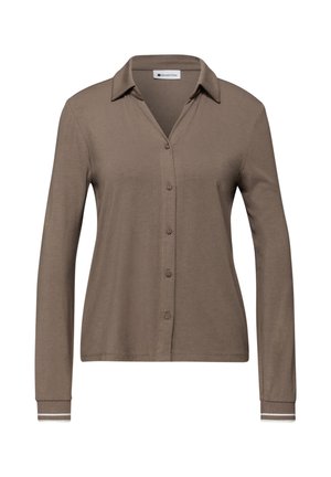 Chemise marron à manches longues avec boutons, col et rayures blanches sur les poignets, en tissu doux et texturé.