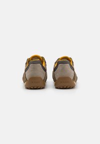 Brown and gray hiking shoes with yellow accents, mesh and suede materials, sturdy rubber soles, and GEOX branding on the heel.