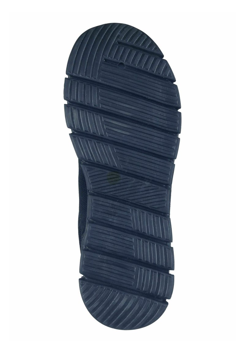 Zwarte rubberen schoenzool met een gestructureerd patroon, diepe groeven en loopvlakken voor grip. Ronde neus en versterkte randen zichtbaar.
