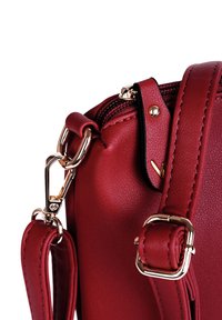 Rote synthetische Lederhandtasche mit Reißverschluss, goldener Hardware und abnehmbarem Tragegurt. Verfügt über eine glatte Textur und dekorative Steppnähte.