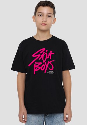 Black cotton t-shirt featuring a large pink graphic text "Saja Boys" on the front, with a smaller white logo at the bottom.