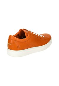 Orange leather sneaker with white laces and rubber sole. Features textured surface and rounded toe design, with a logo accent on the back.