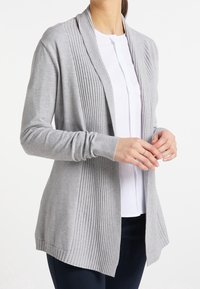 Light gray cardigan made of soft knit fabric, featuring ribbed detailing along the front, open front design, and long sleeves.