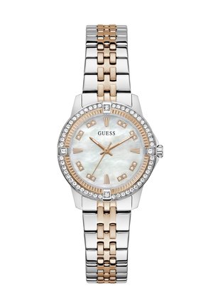 Two-tone silver and rose gold Guess wristwatch with crystal-studded bezel, mother-of-pearl dial, and gold hour markers and hands.