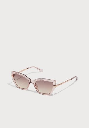 Cat-eye sunglasses with pink semi-transparent frames and gradient lenses. Textured, patterned arms with metallic accents.