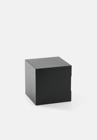 Czarny kwadratowy pudełko o błyszczącym wykończeniu, z subtelnymi geometrycznymi liniami i wycięciem. Minimalne logo na górnej powierzchni.