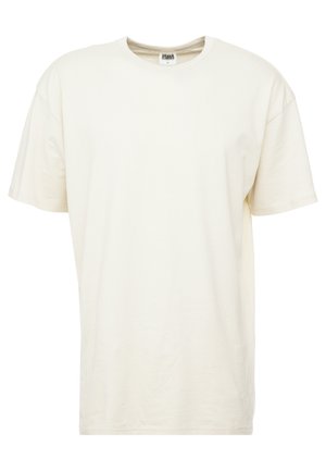 Korte mouwen, ronde hals t-shirt in lichtcrème kleur. Gemaakt van zacht katoen met een relaxte pasvorm en minimale naden.