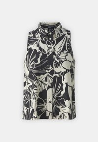 Blouse sans manches avec un col à revers, présentant un motif floral noir et crème. Confectionnée dans un tissu léger, avec une fermeture à boutons sur le devant.