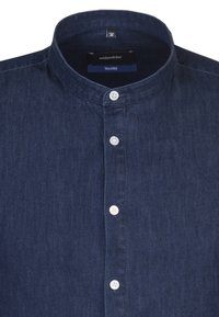 Mörkblå denimskjorta med ståkrage, utrustad med vita knappar, figursydd passform och en slät textur. Varumärkesetikett synlig inuti kragen.