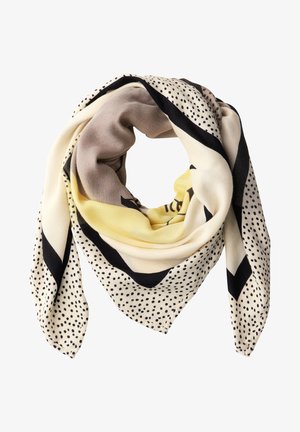 Pañuelo cuadrado doblado en forma de lazo con colores beige, amarillo y negro, que presenta patrones de lunares y rayas audaces.