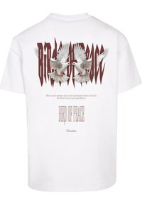 White short-sleeve t-shirt featuring a graphic of two doves with wings spread and bold text reading "BIRD OF PEACE" and "Freedom."