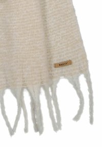 Écharpe couleur crème avec un motif texturé, dotée de bords frangés et d'une petite étiquette en cuir de marque sur un côté.