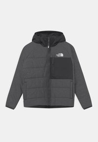 Šedá a černá mikina s kapucí na zip, prošívanými panely a náprsní kapsou s logem The North Face. Hladká, lehká látka.