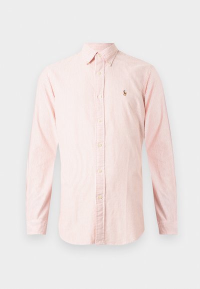 Pasiasta koszula w jasnym różowym i białym kolorze z długimi rękawami, z kołnierzykiem zapinanym na guziki oraz małym haftem logo na piersi. Materiał bawełniany.