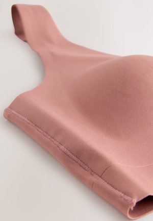 Jasnoróżowy biustonosz wykonany z gładkiej tkaniny, z miękką, zaokrągloną miseczką, szerokimi ramiączkami i starannym przeszyciem na brzegach.