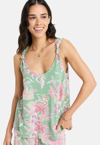 Floral sleeveless top in mint green with pink and white flower patterns, featuring knotted shoulder straps and a relaxed fit.