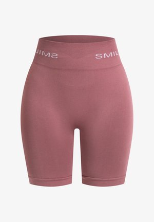 Pantalones cortos de ciclismo de tiro alto y acanalados en un suave color malva con "SONRÍE" impreso en blanco en la cintura. Tejido suave y elástico.