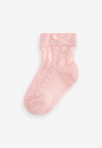 Calzino lavorato a maglia rosa chiaro con un motivo testurizzato e un fiocchetto decorativo sul risvolto. Materiale morbido con una parte superiore a coste e punta arrotondata.