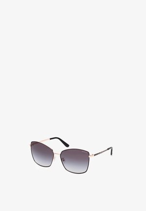 Sunglasses with a rose gold metal frame and black arms. Gradient gray lenses in a geometric shape. Notable brand logo on the arm.