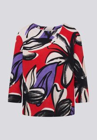 Red top with black, white, and purple floral pattern; features a round neckline and three-quarter sleeves, made from textured fabric.