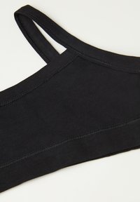 Černá tkanina braletka s tenkými ramínky, hladkým povrchem a plochými švy. Má jednoduchý design bez dalších vzorů nebo kovových doplňků.