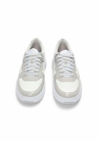 White and light gray sports sneakers with a glossy finish, perforated toe, and textured laces. Features "HUGO" branding on the tongue.