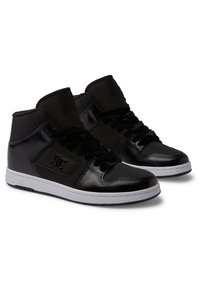 Black high-top sneakers with a glossy patent leather finish, textured fabric accents, and white rubber soles. Features laces and logo detail.