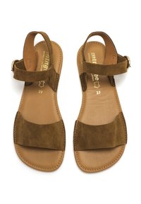 Sandalias de ante marrón con dos correas verticales anchas, diseño de punta abierta y una hebilla en la correa del tobillo. Suela interior color beige y detalles de costura.