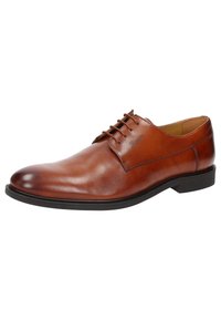 Scarpa in pelle marrone con lacci, caratterizzata da una superficie liscia, punta arrotondata e suola nera a contrasto. Cuciture minime e accenti del logo visibili.
